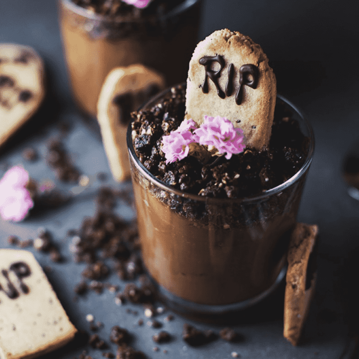 Chocolate mousse in a glass with a RIP tombstone cookie on top.