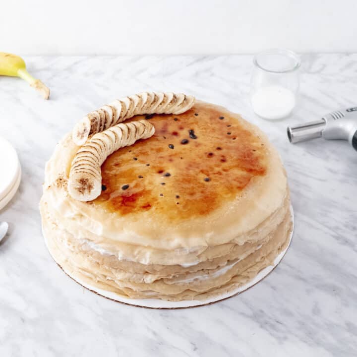 A layered crepe cake with caramelized top.