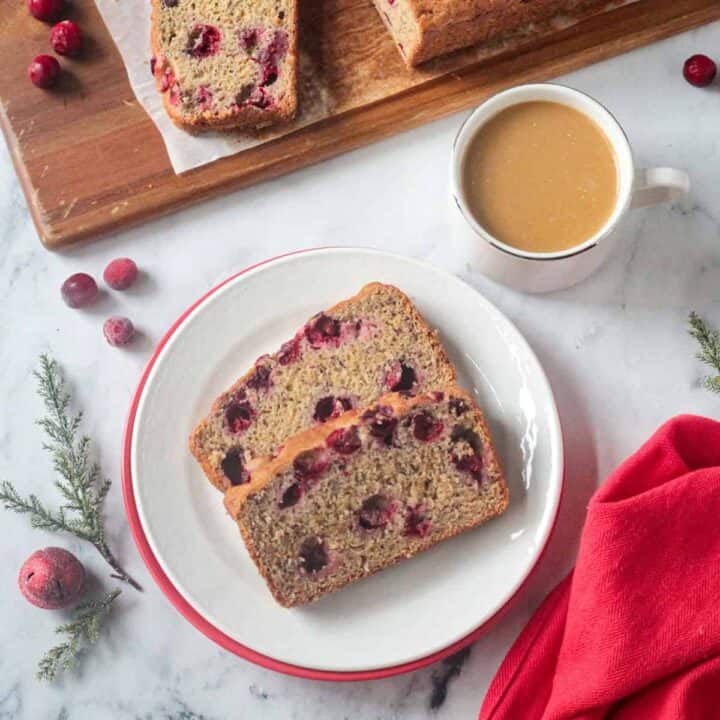 Two slices of banan bread with cranberries in.