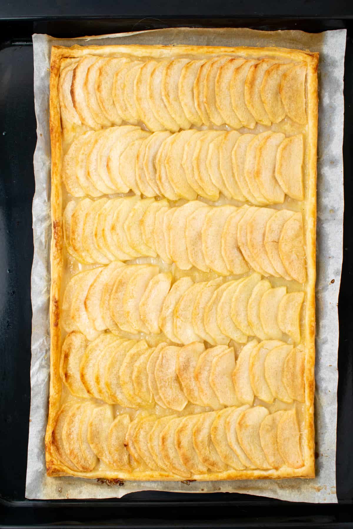 A baked apple tart with golden brown pastry.