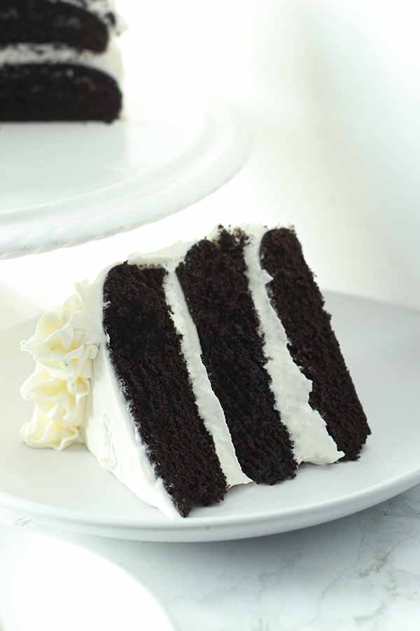 A slice of black and white three layer cake.