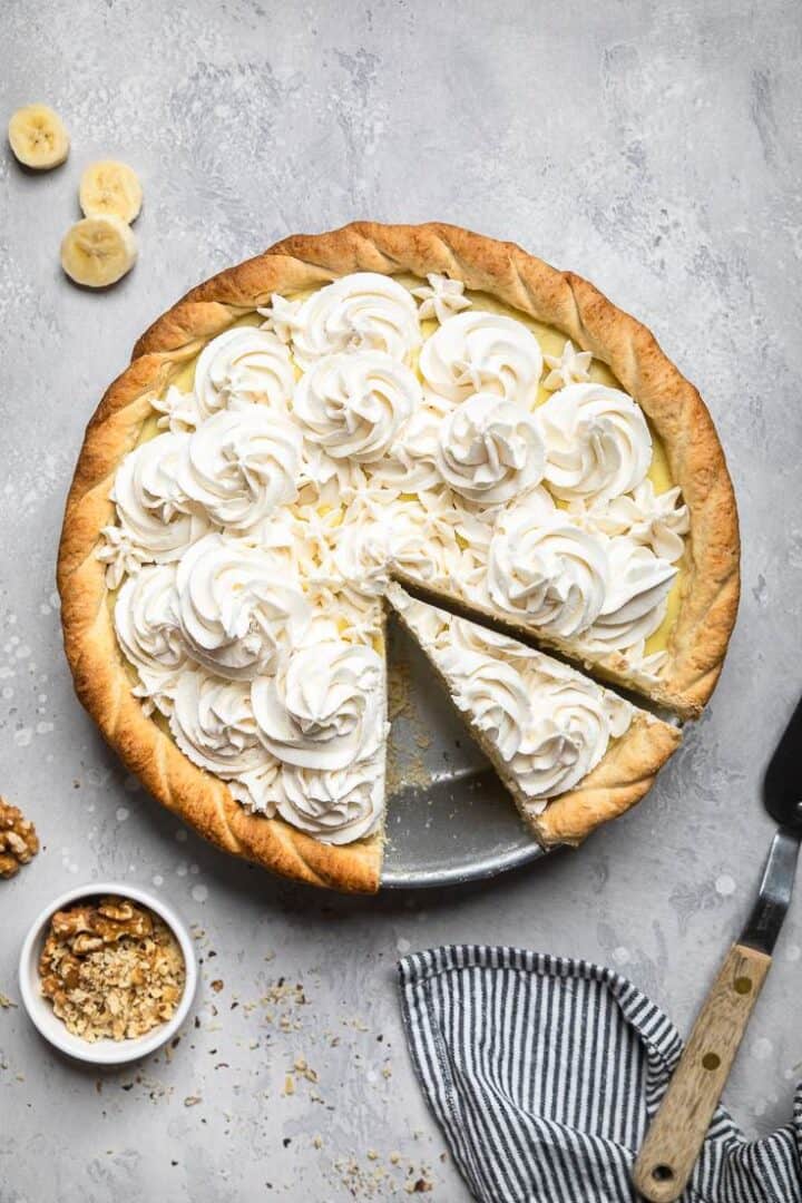 A pie topped with swirls of vegan whipped cream.