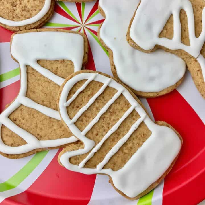 Mitten and stocking shaped cookies decorated with white icing.