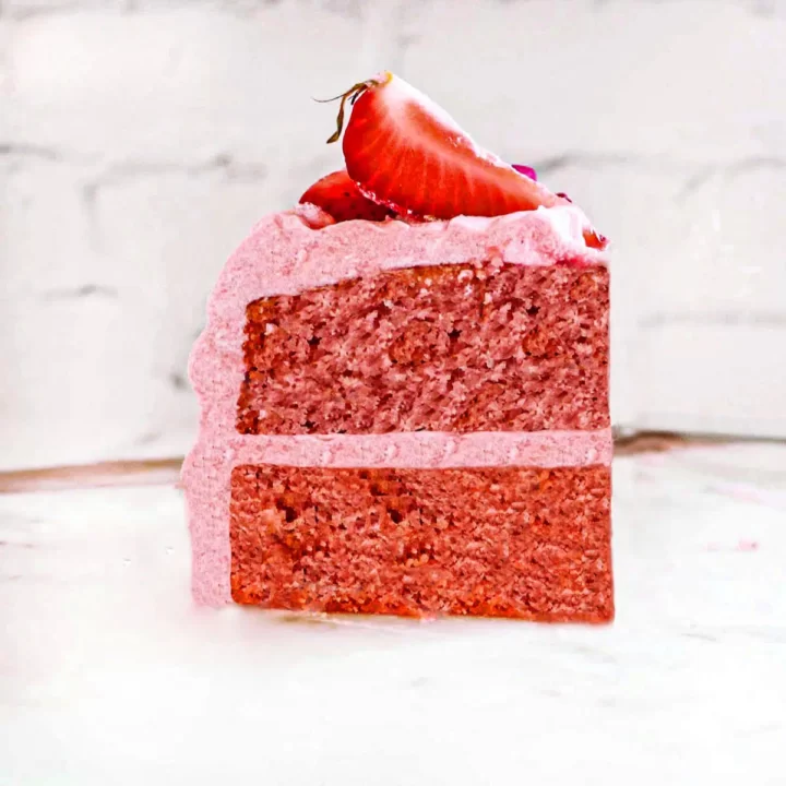 A slice of two layer strawberry cake.