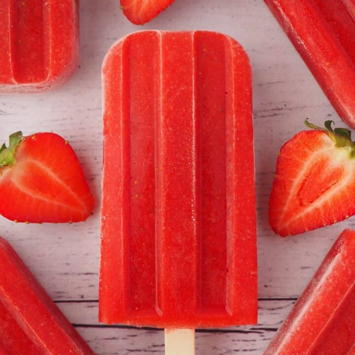 A bright red strawberry popsicle.