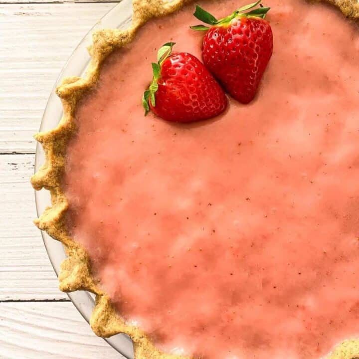 A strawberry pie with fluted pie crust.