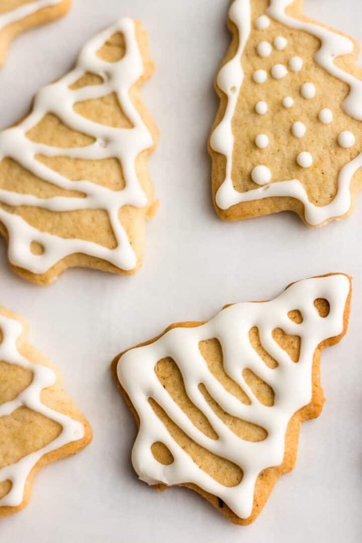 Christmas tree shaped cookies with white icing.