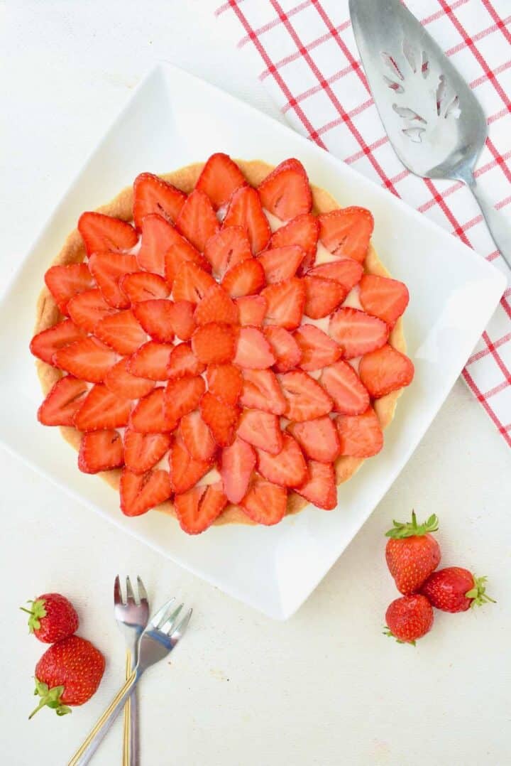 A beautifully decoarted strawberry tart.