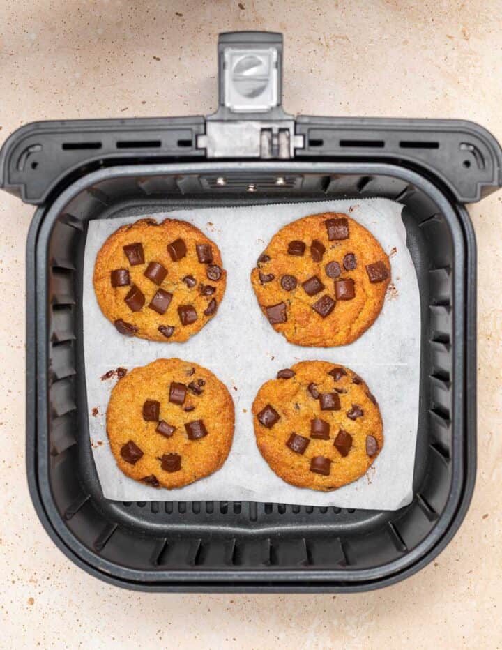 Four cookies in an air fryer.