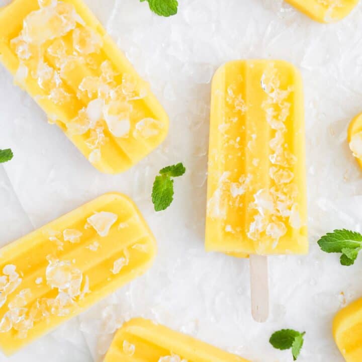 Mango popsicles on ice with mint.