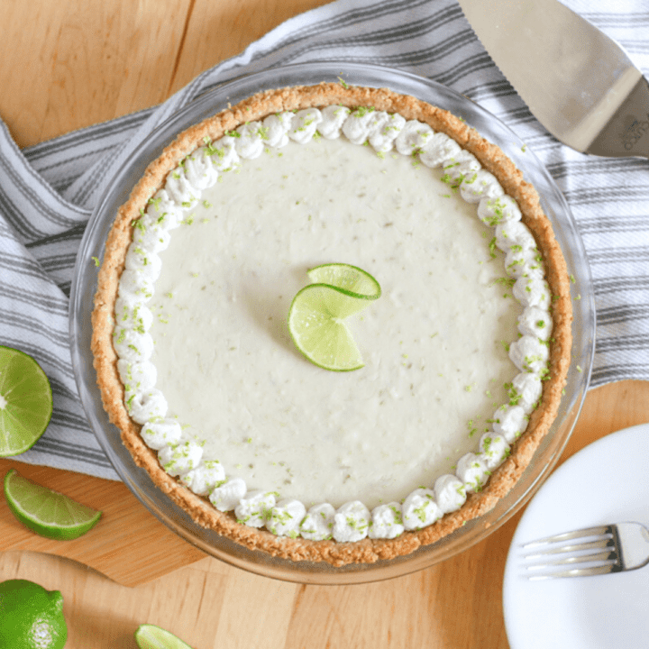 A lime pie in a glass pie dish.