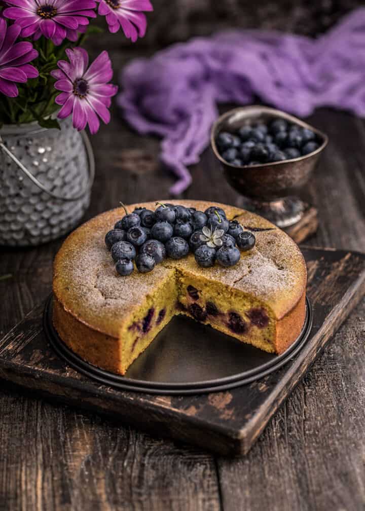 A lemon cake topped with fresh blueberries.