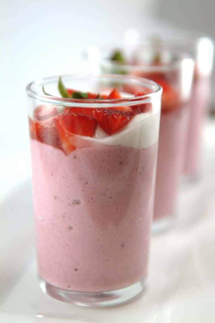 Strawberry mousse in a tall glass.