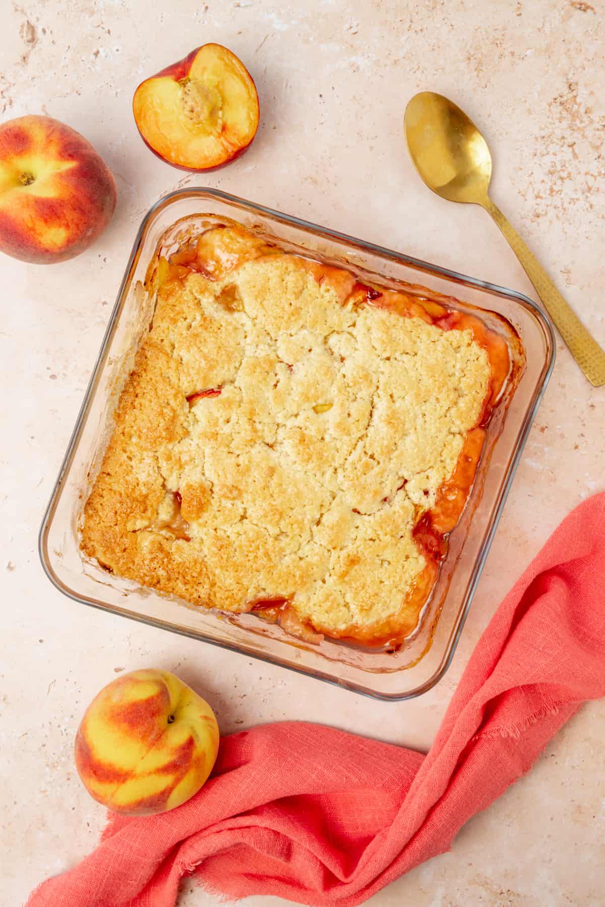 Freshly baked peach cobbler with a light golden brown topping.