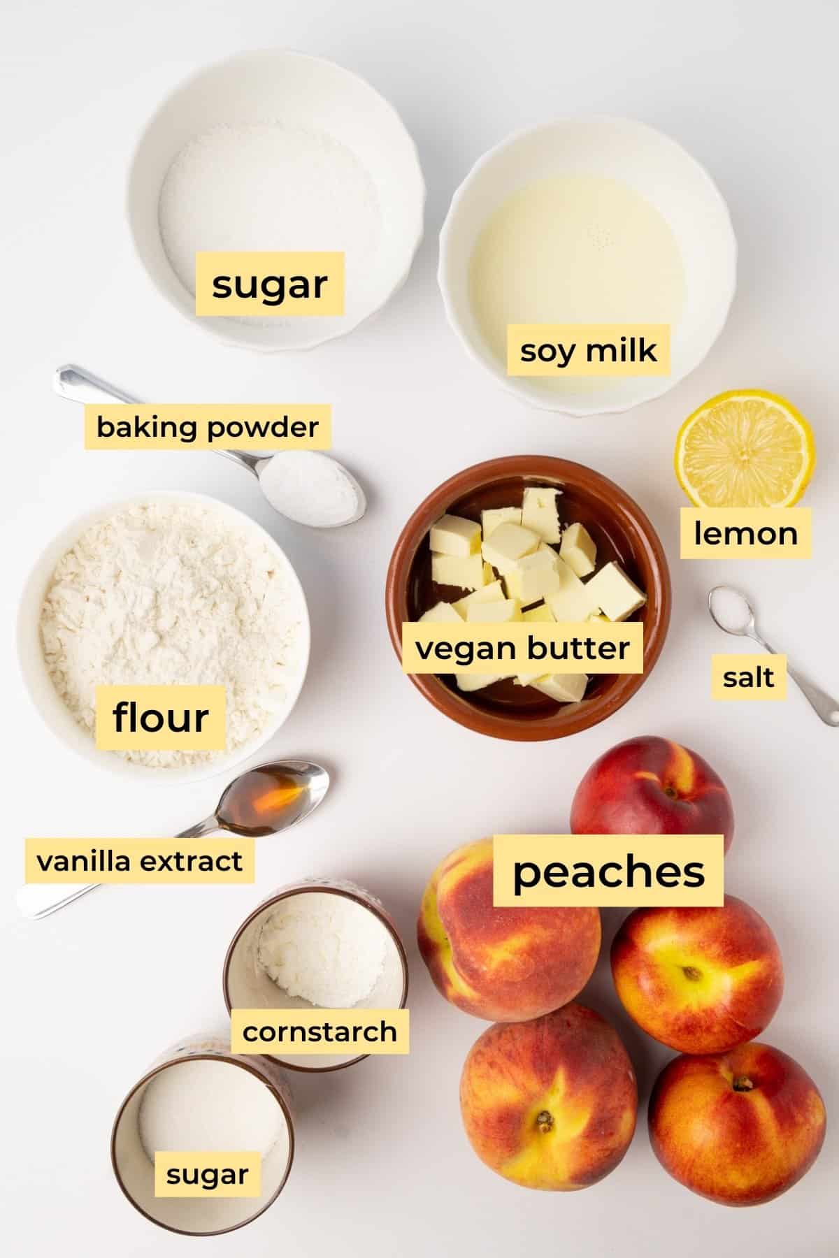 Ingredients for vegan peach cobbler on a white background.