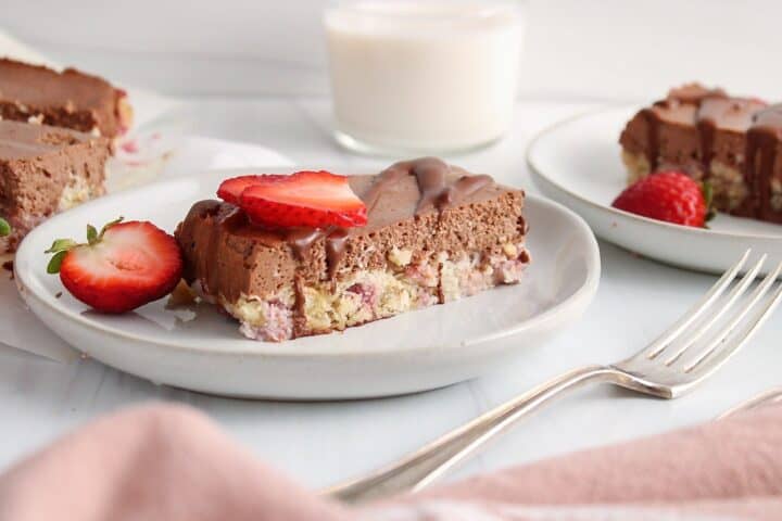 A piece of chocolate strawberry slice on a plate.