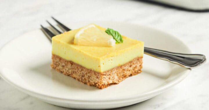 A pale lemon par on a plate with a fork.