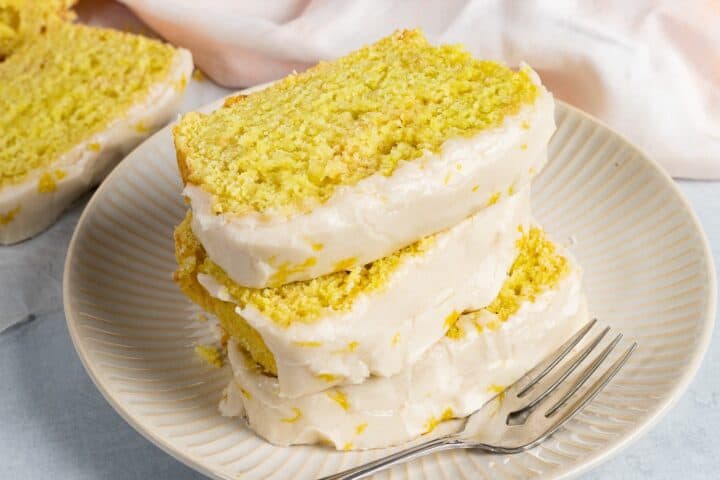 A stack of three slice of vegan lemon loaf.