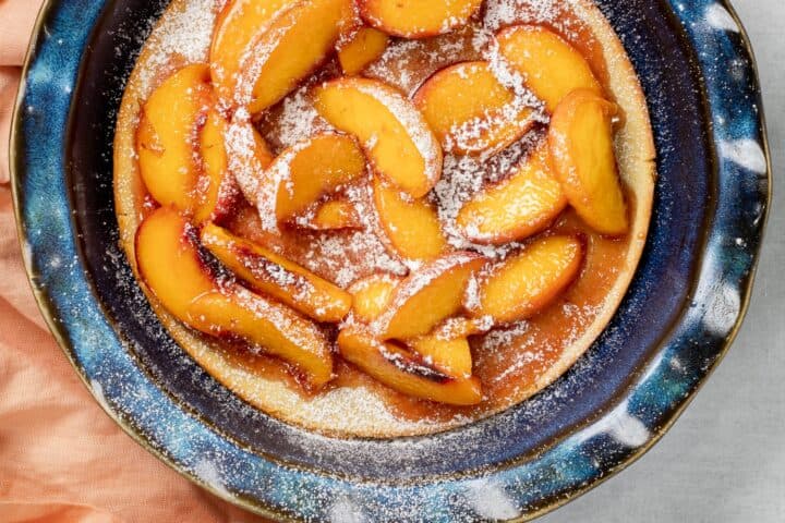 A fluffy cake topeed with juicy sliced peaches.