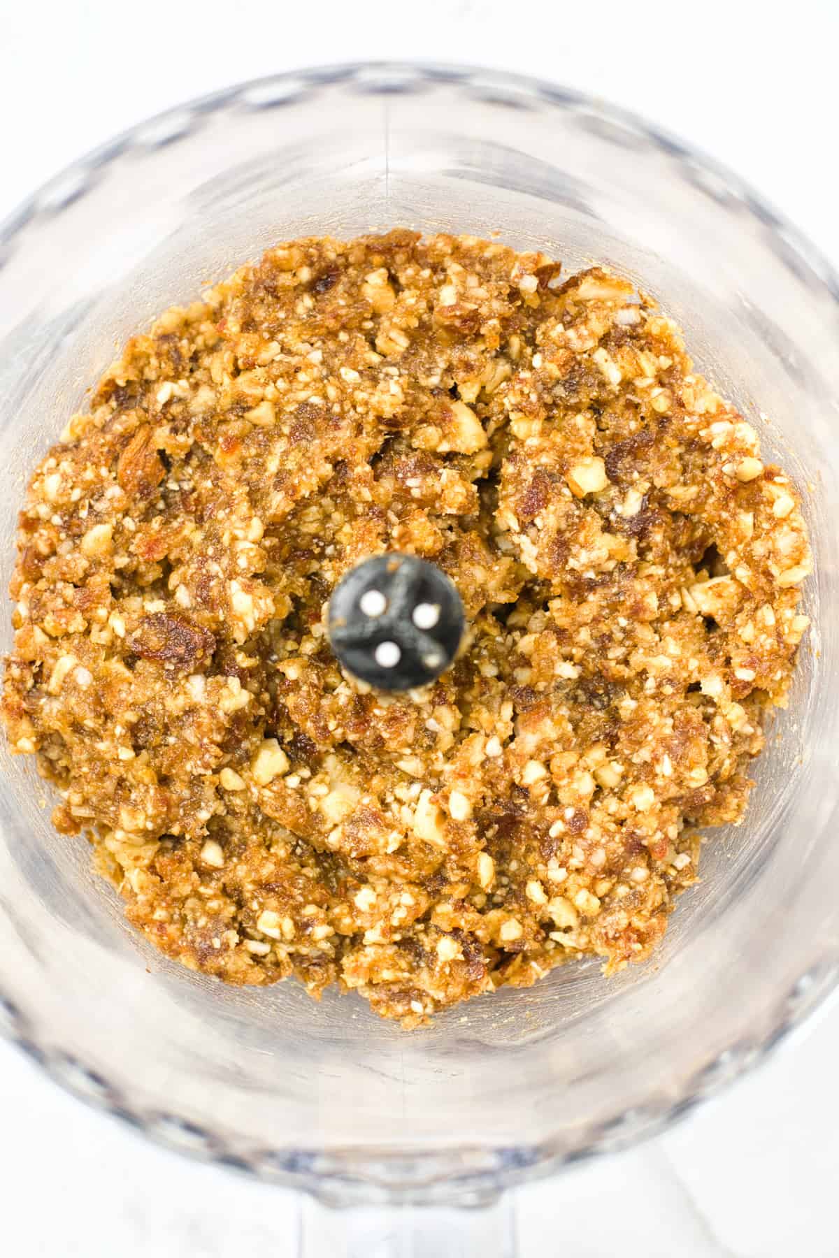 Blended dates, nuts and coconut in a food processor.