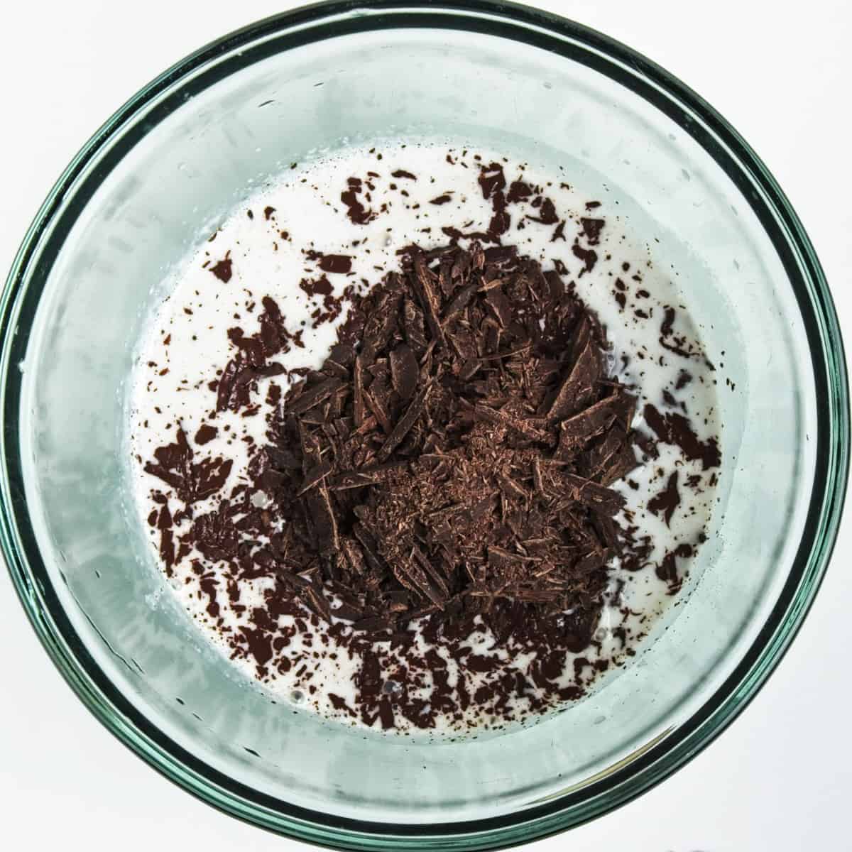Finely chopped chocolate in a bowl with cococnut milk.