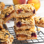 A stack of three peach crumble bars.