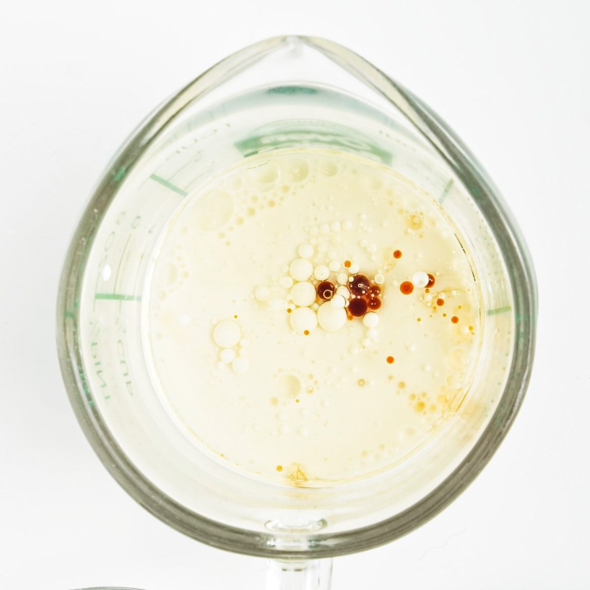 Wet ingredients in a glass measuring cup.