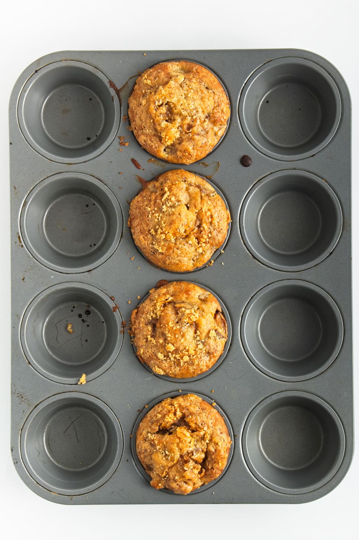 Four golden brown and well risen peach muffins.