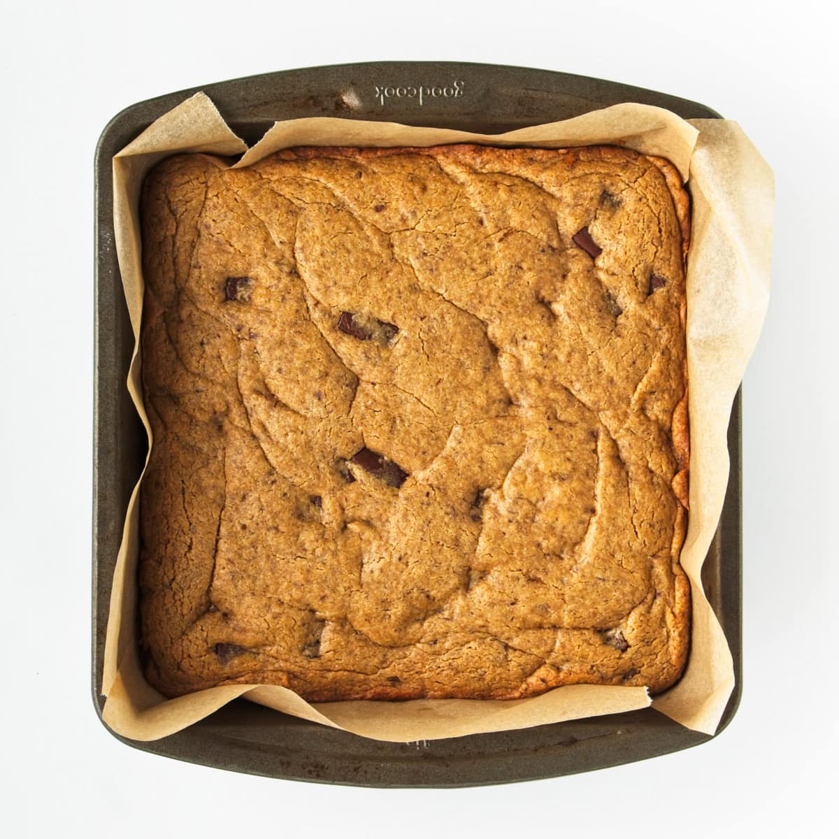 Baked blondies in a lined tin.