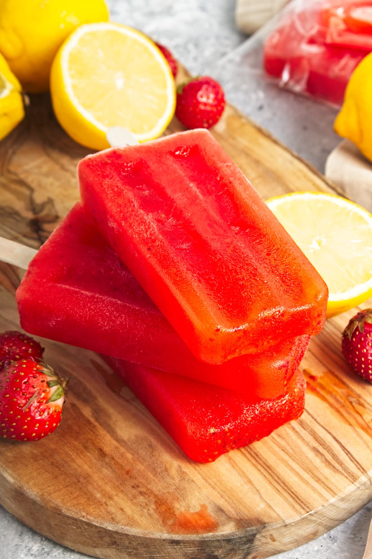 A stack of three bright red popsicles.