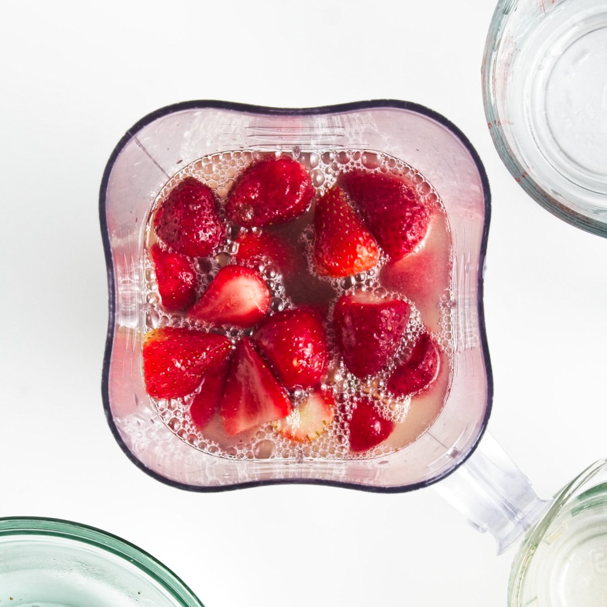 Strawberries and lemonade in a blender.