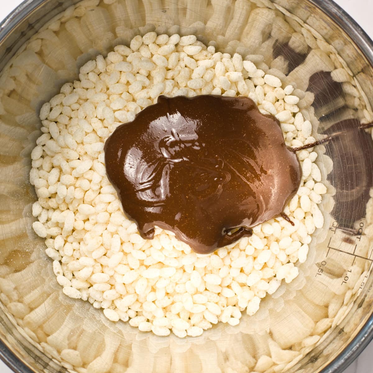 Crisp rice ceral and chocolate mixture in a mixing bowl.