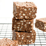 A stack of three chocolate crunch bars with rice cereal.