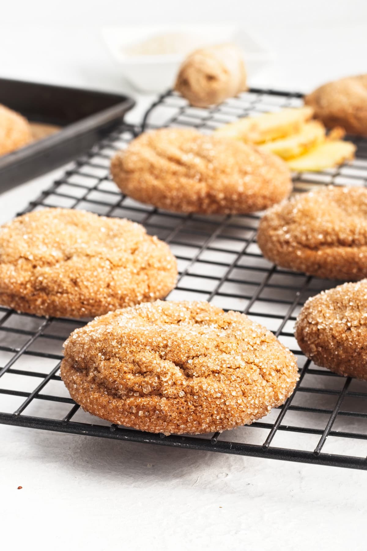 The crunchy sugar coating of the cookie can be seen as it cools on a wire rack.